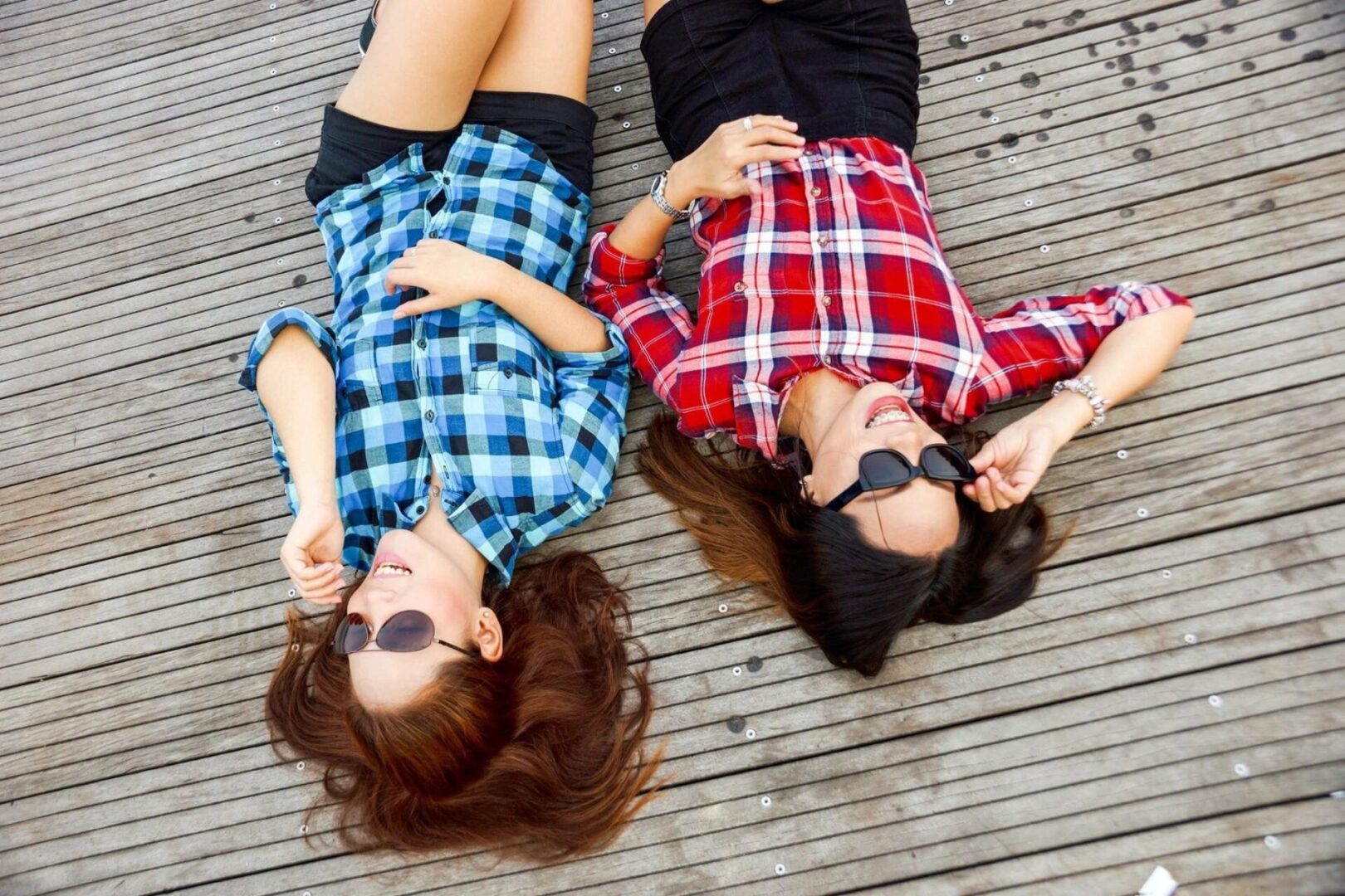 Two woman laying on the floor.