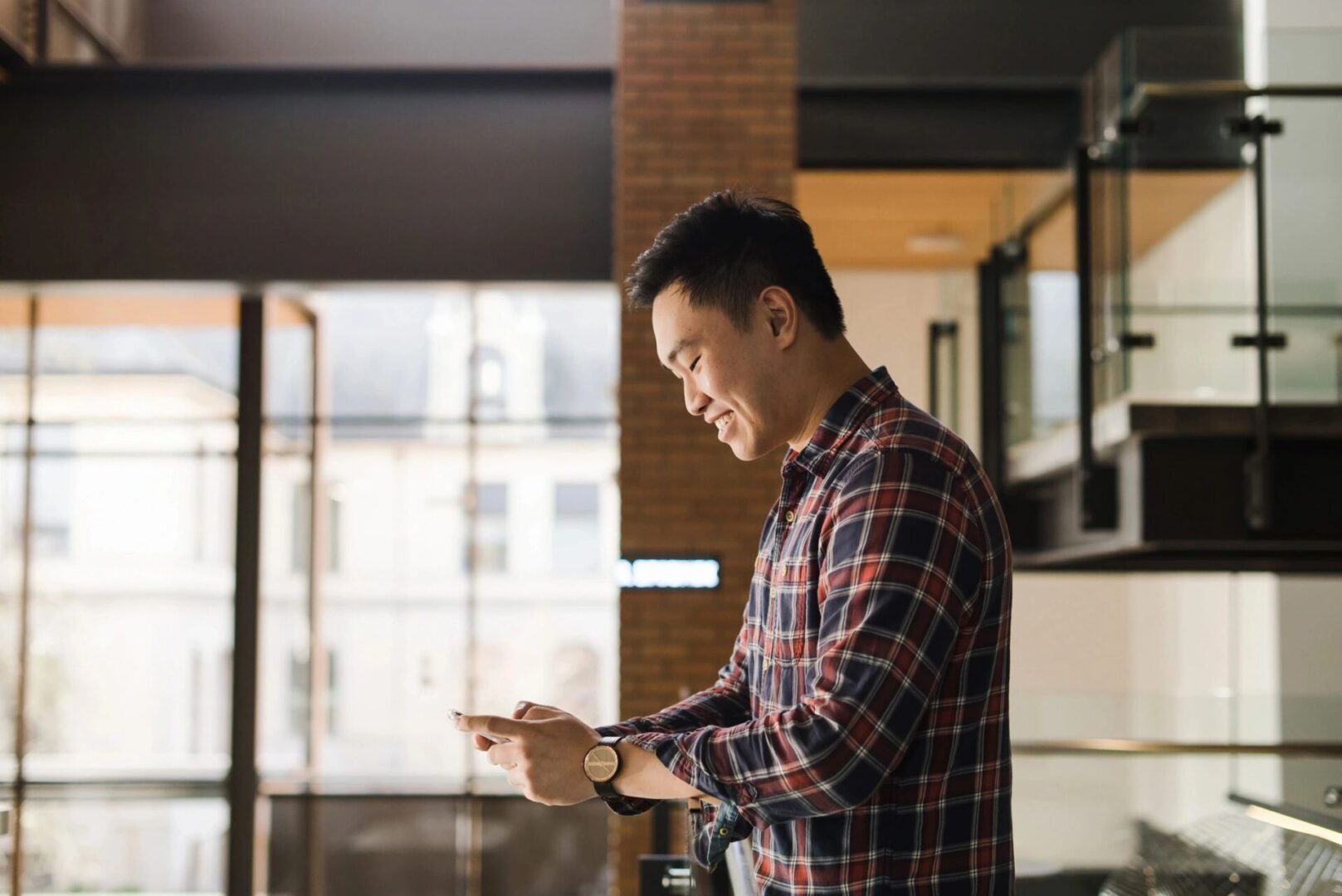 A man standing looking at his phone